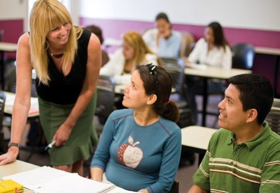 A WIE teacher helping students during an English lesson