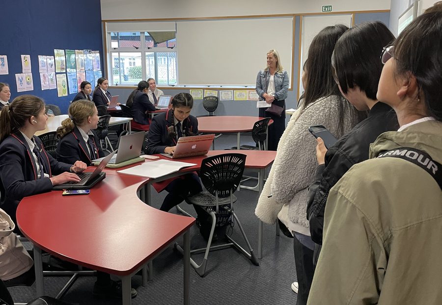 WIE students using laptops during an English learning activity