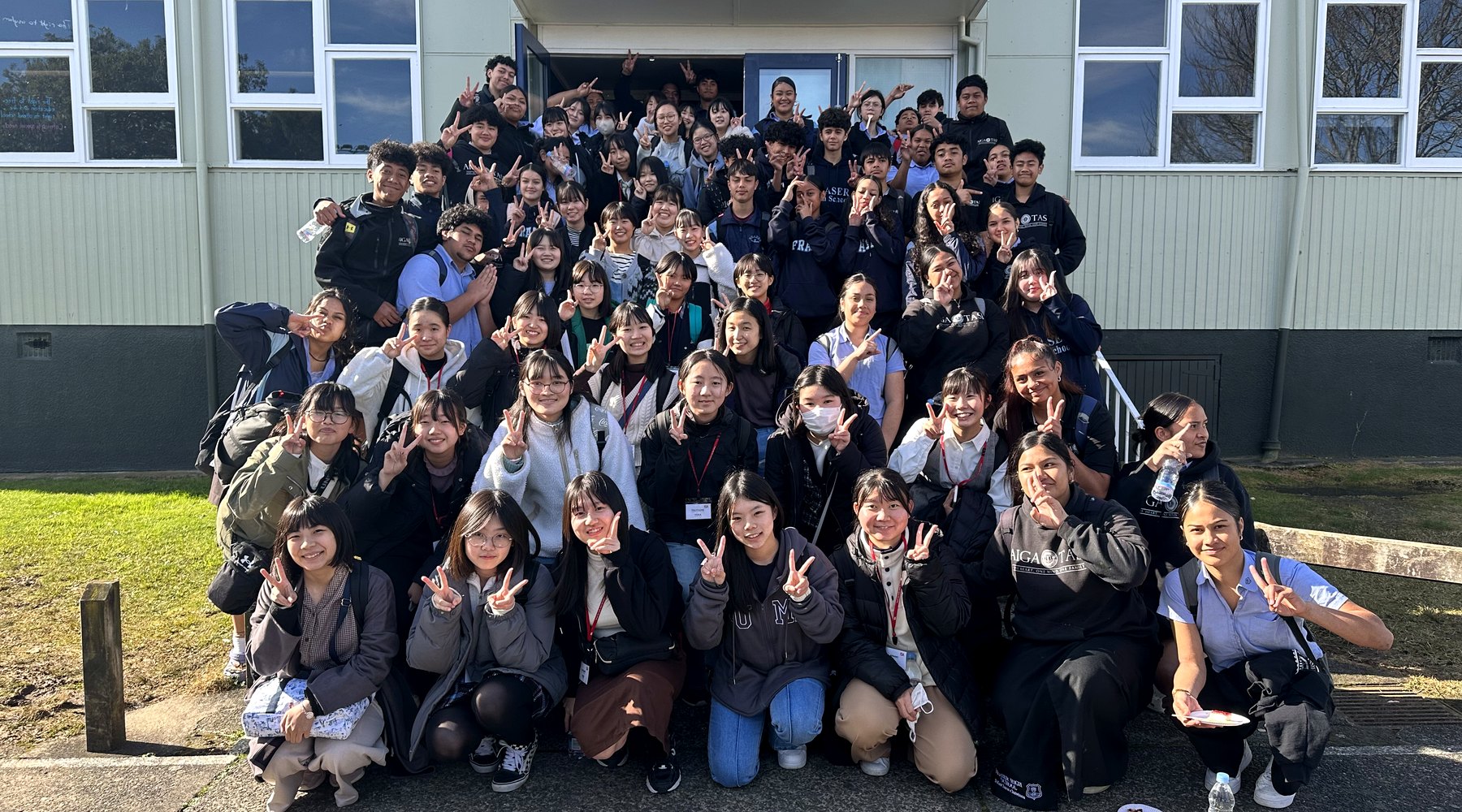 International high school students outside a school building